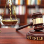 Juvenile law gavel rest with gavel on top of table Juvenile law gavel rest with gavel on top of table