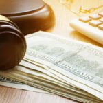 Bail bond concept shown with gavel and 100 dollar banknotes Bail bond concept shown with gavel and 100 dollar banknotes