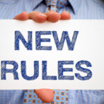 white sign that reads new rules white sign that reads new rules
