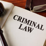 Book with title criminal law on a table. Book with title criminal law on a table.