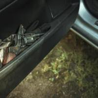 the-metal-pistol-revolver-is-in-the-plastic-pocket-of-the-car-door